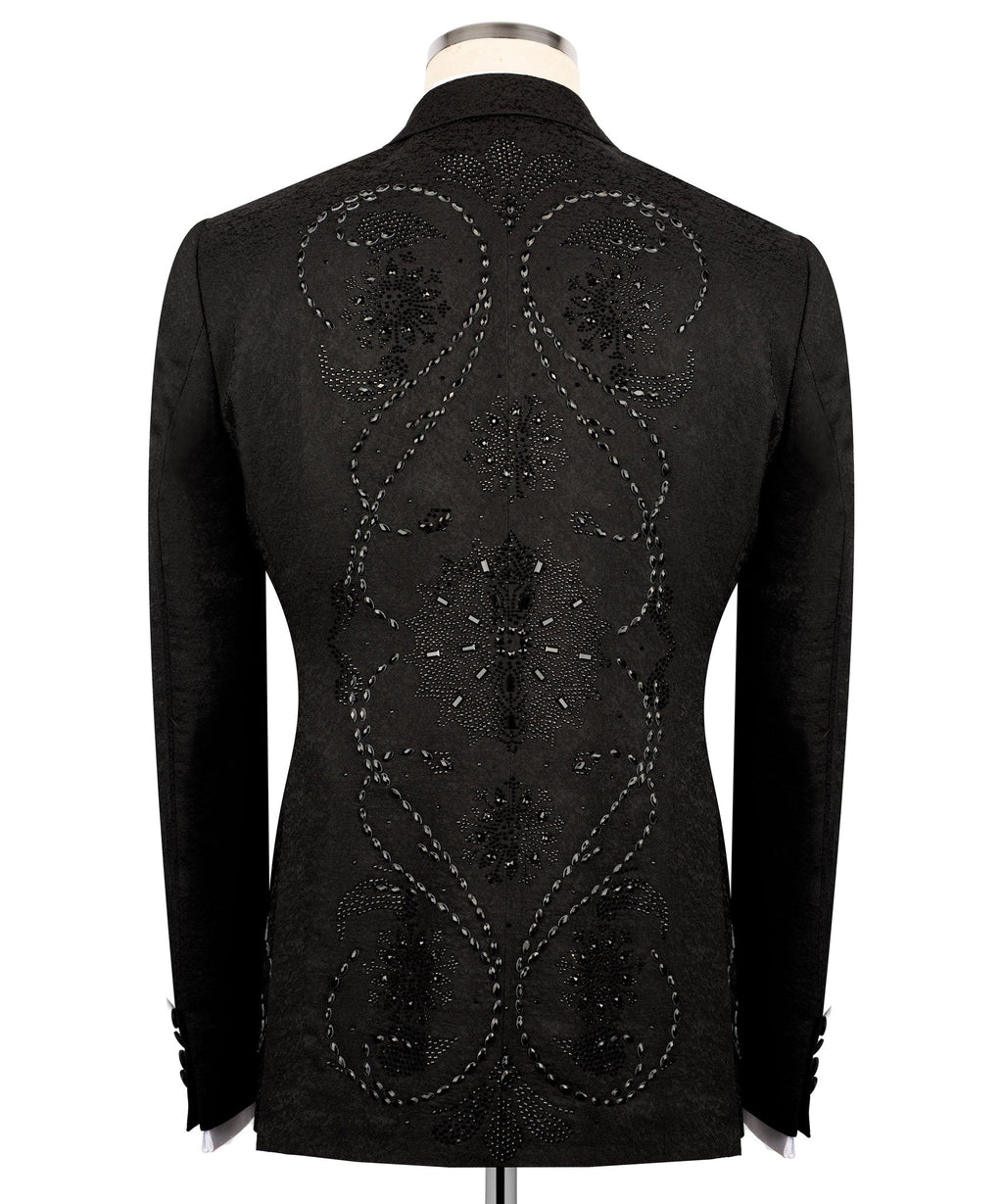 Back view of black embroidered tuxedo jacket with ornate circular and starburst motifs