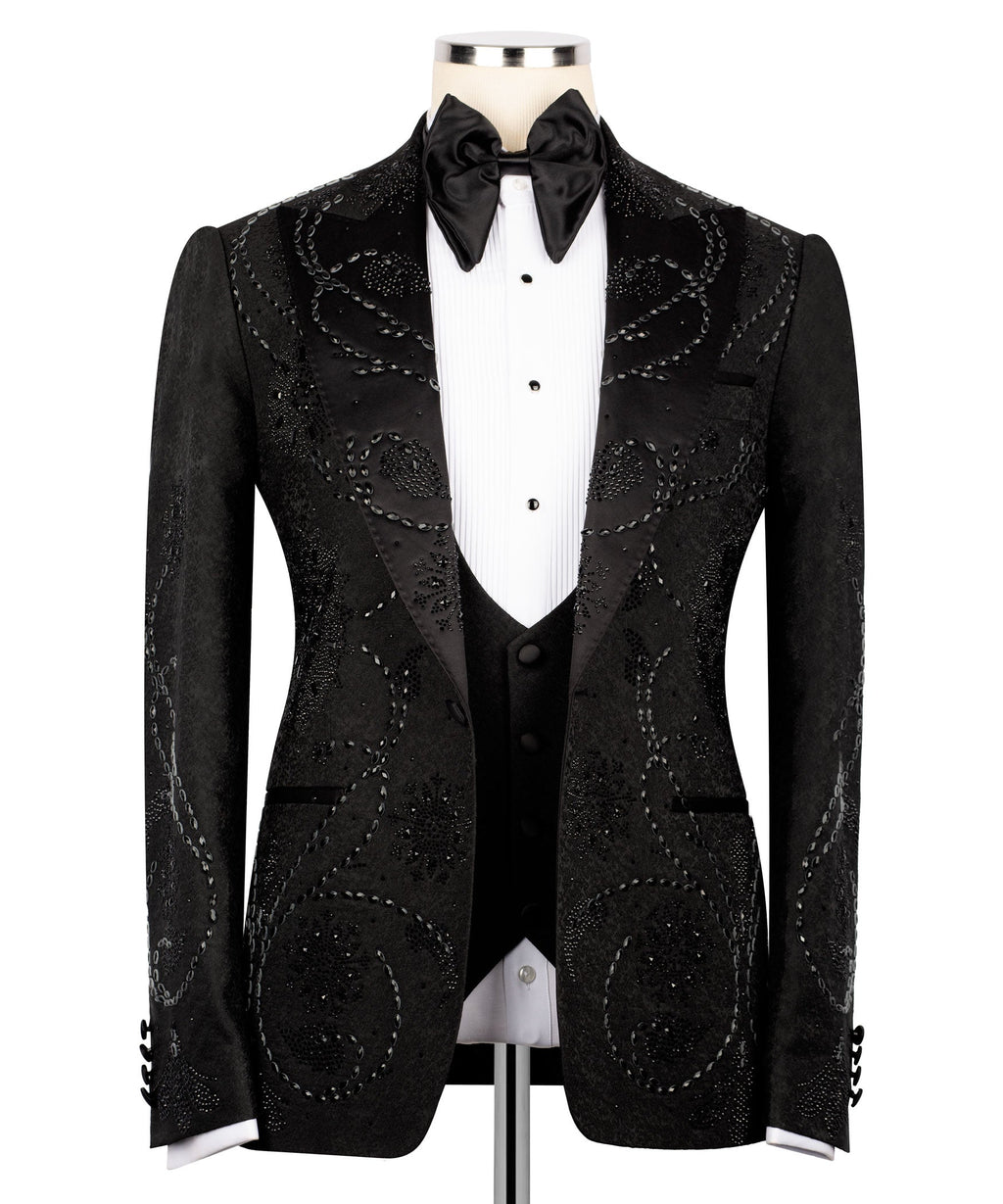 Black embellished tuxedo jacket with satin lapels, bow tie, and front button closure