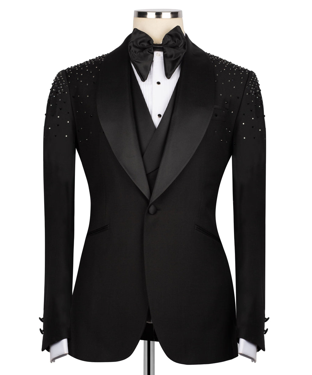 Black tuxedo jacket with jeweled shoulder stonework, satin lapels, and bow tie