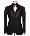 Black tuxedo jacket with jeweled shoulder stonework, satin lapels, and bow tie