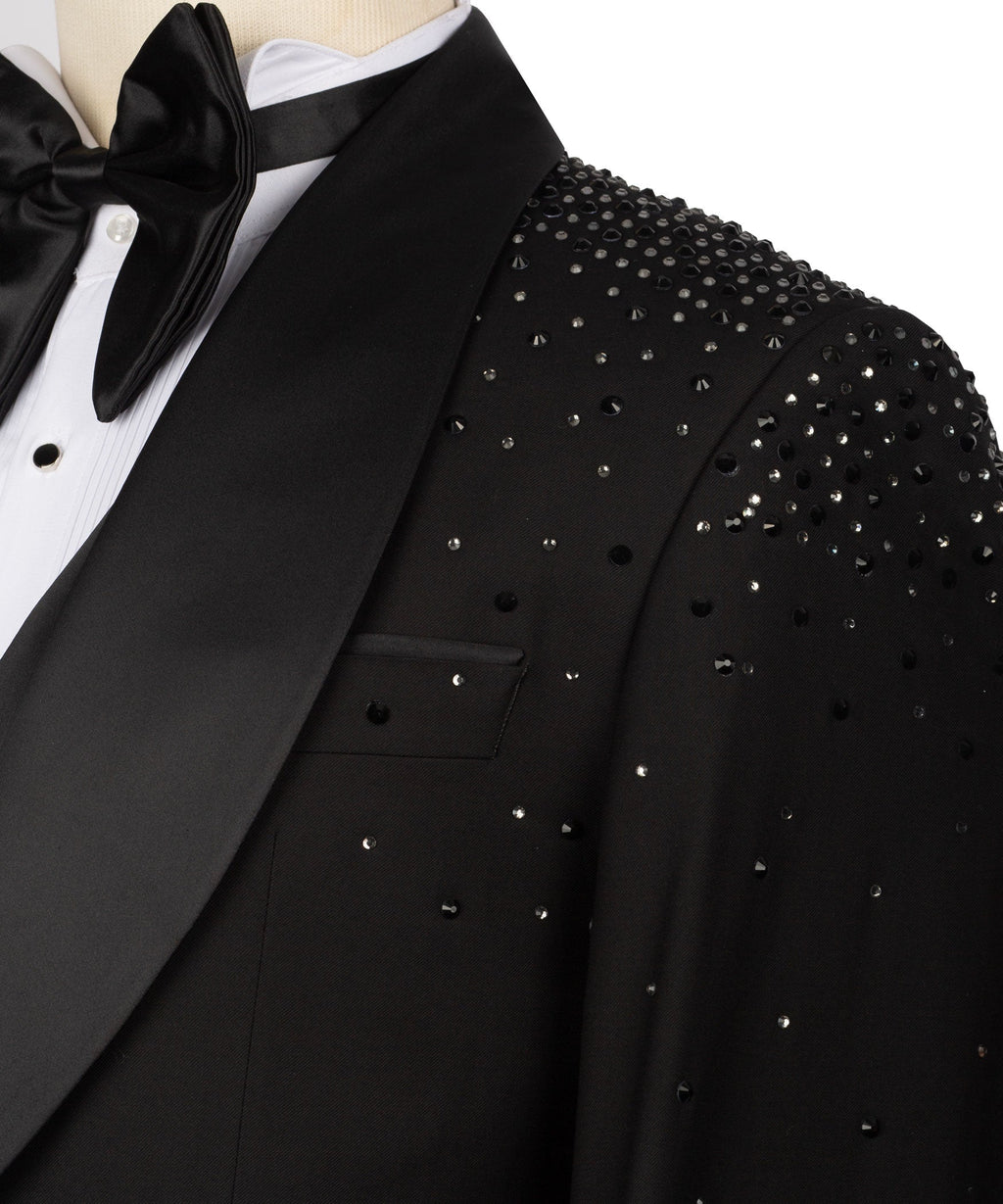 Close-up of black tuxedo jacket lapel with stone-studded shoulder and pocket