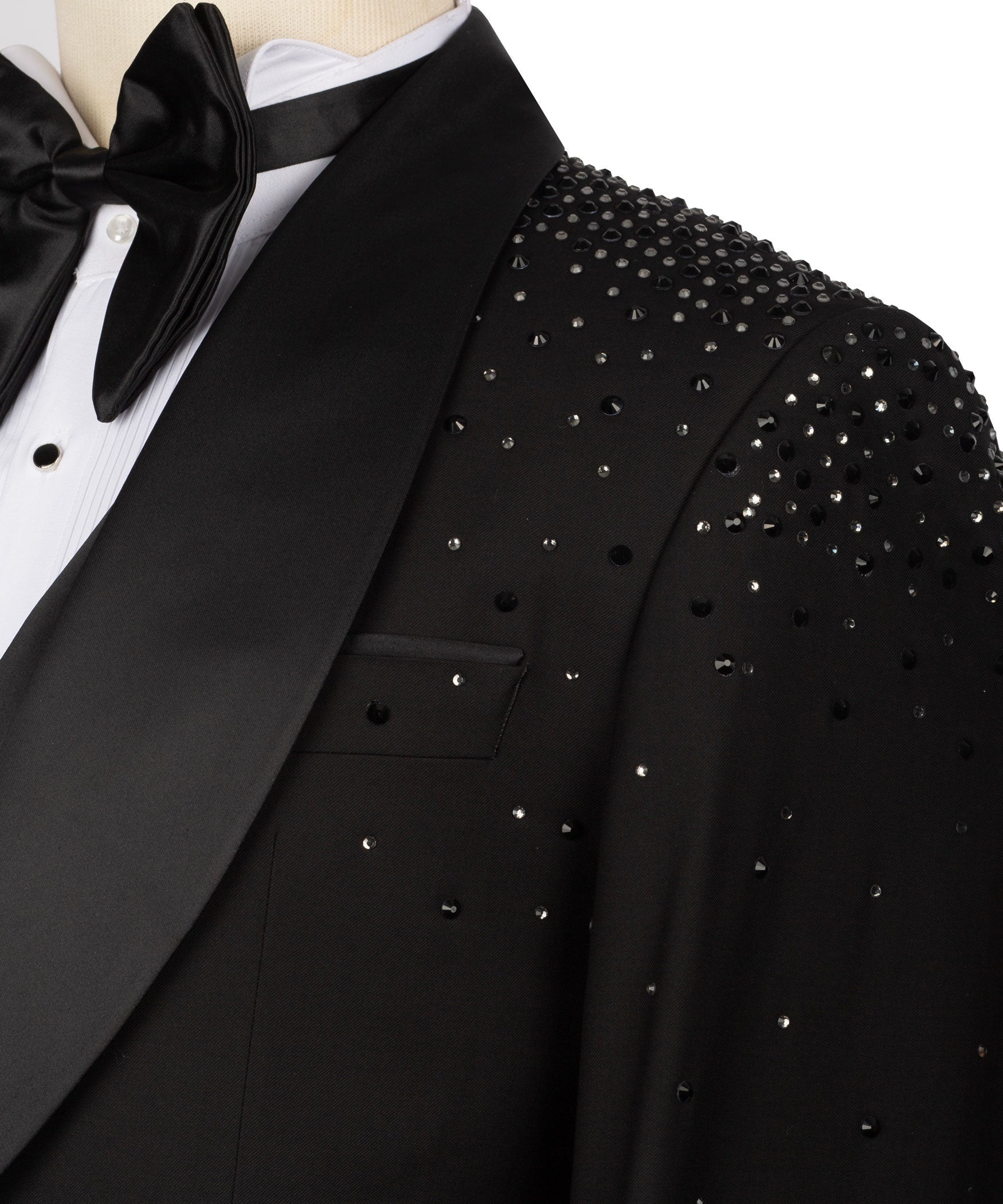 Close-up of black tuxedo jacket lapel with stone-studded shoulder and pocket