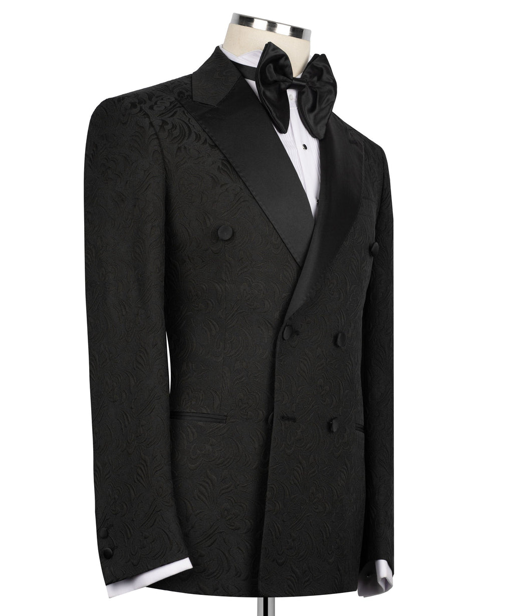 Black tuxedo jacket with oversized bow tie, double-breasted buttons, patterned fabric