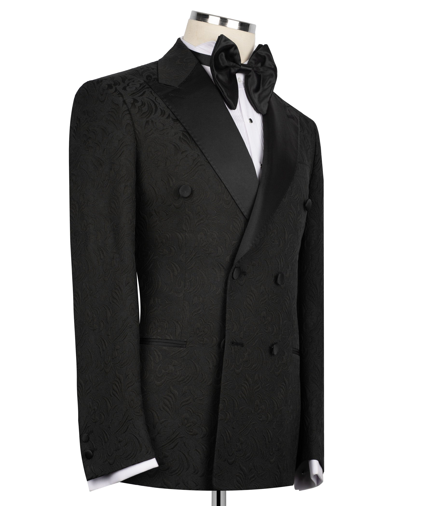 Black tuxedo jacket with oversized bow tie, double-breasted buttons, patterned fabric