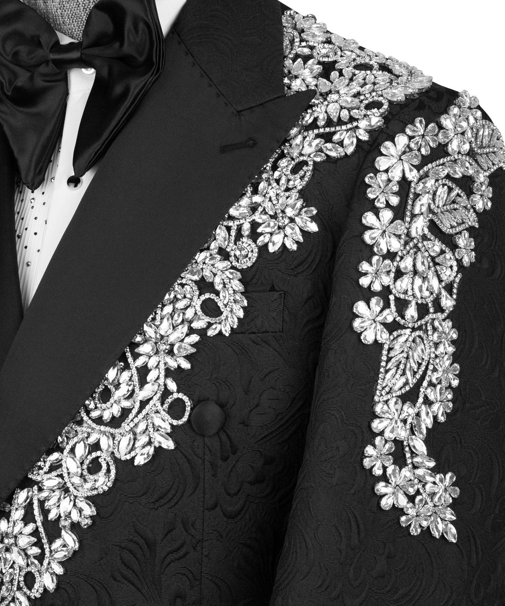 Close-up black tuxedo lapel with sparkling stone floral embroidery and mirrored motifs