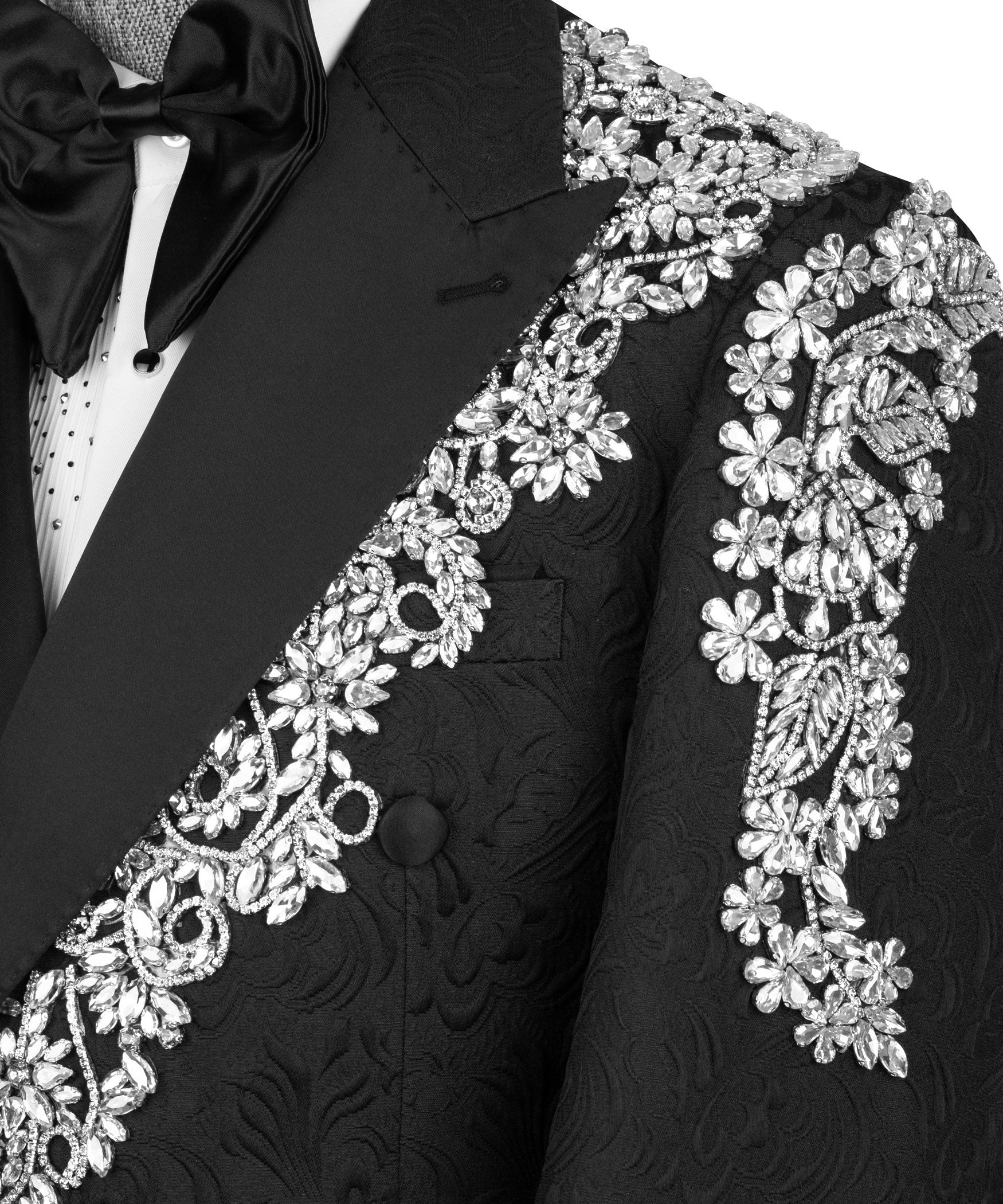 Close-up black tuxedo lapel with sparkling stone floral embroidery and mirrored motifs