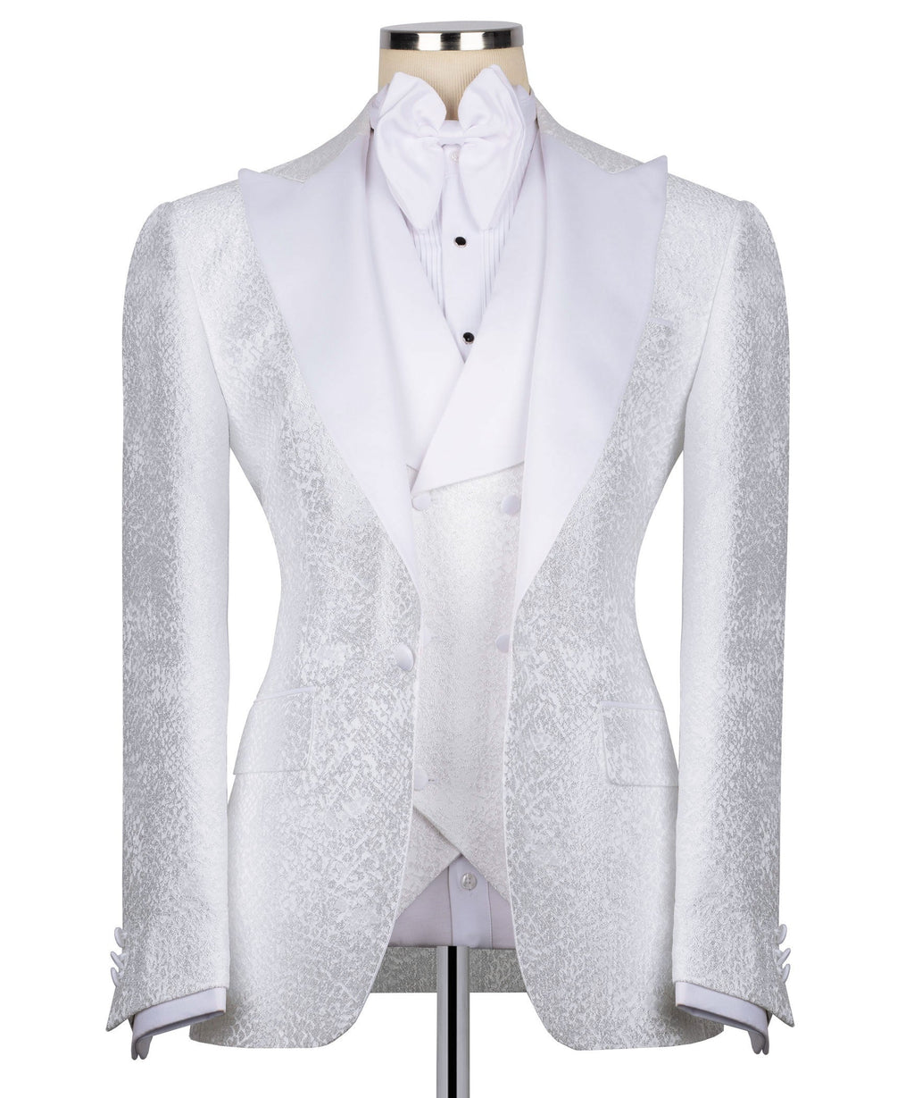 White tuxedo with embellished lapels, bow at neck, vest included, front view
