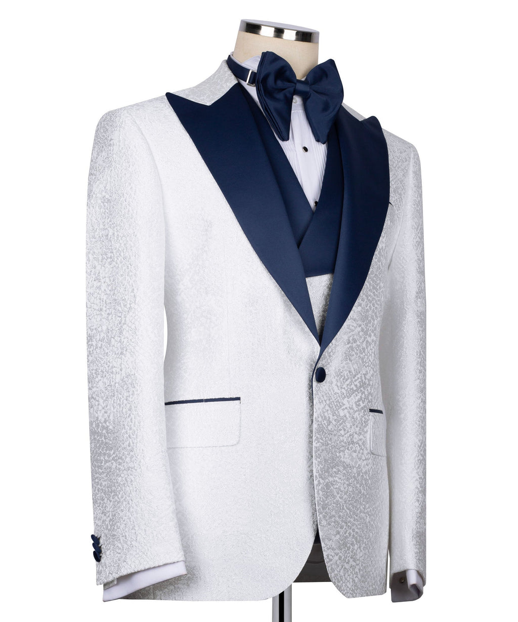 White tuxedo jacket with navy shawl collar, bow tie, and buttoned front