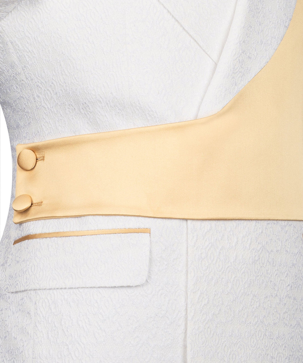 Close-up: gold satin vest across textured white tuxedo jacket with welt pocket