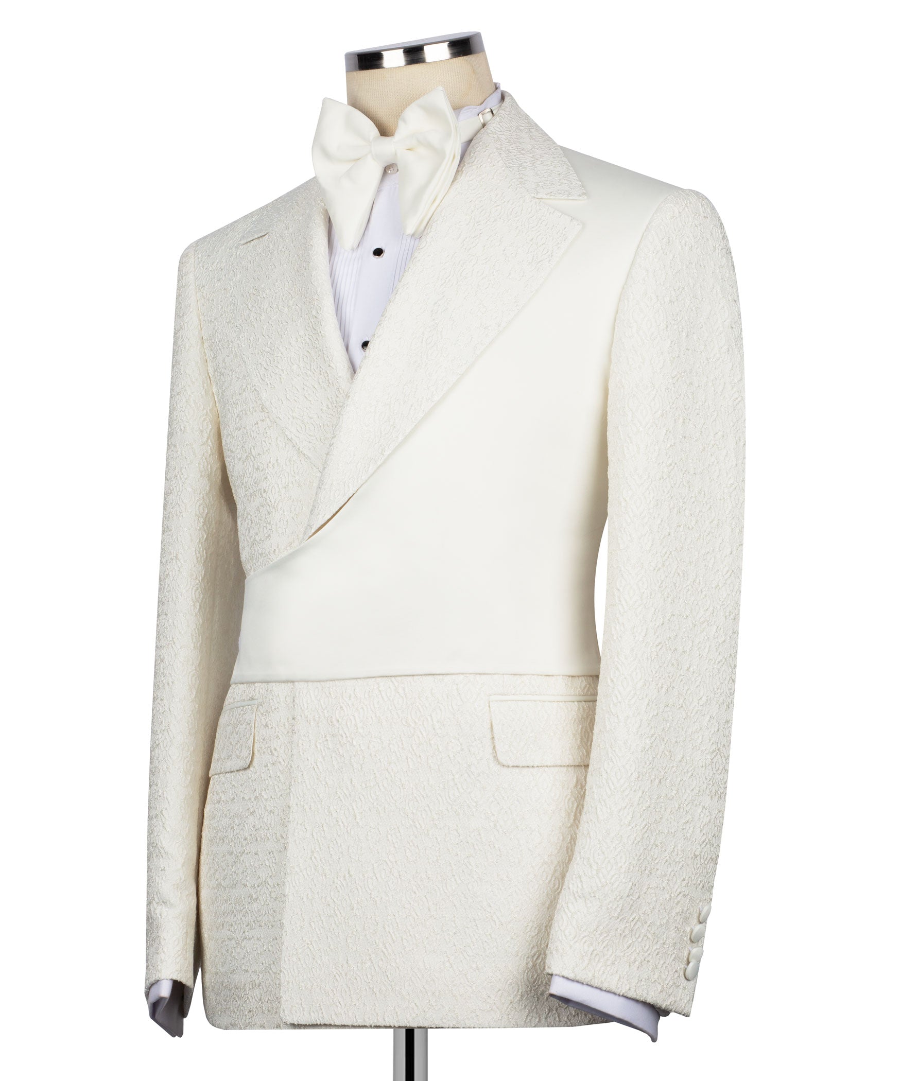 Cream tuxedo jacket with satin-like lapels, bow tie, and matching trousers