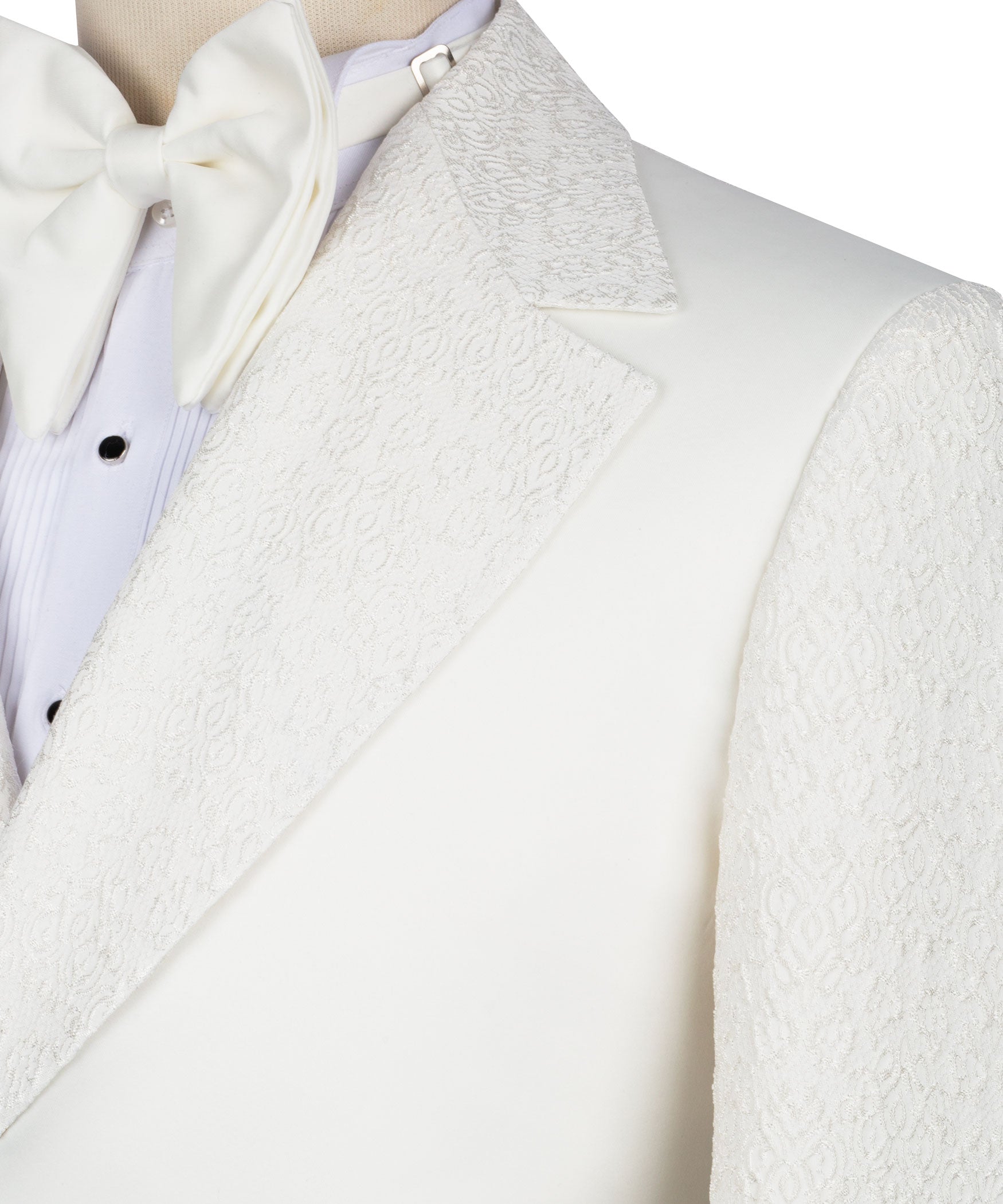 Cream textured tuxedo jacket lapels with white bow tie and vest front