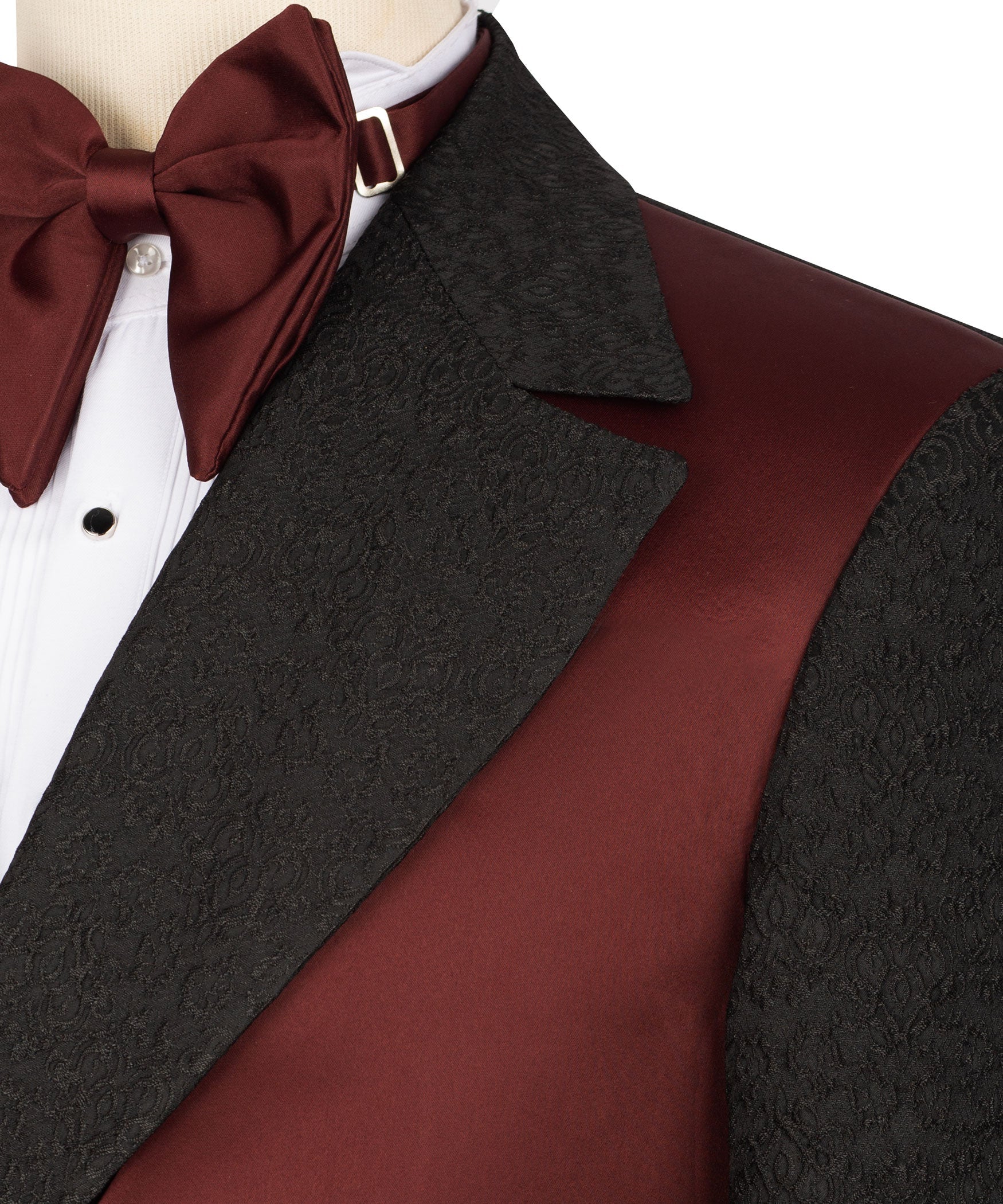 Burgundy bow tie with white shirt, black patterned lapel, maroon vest panel