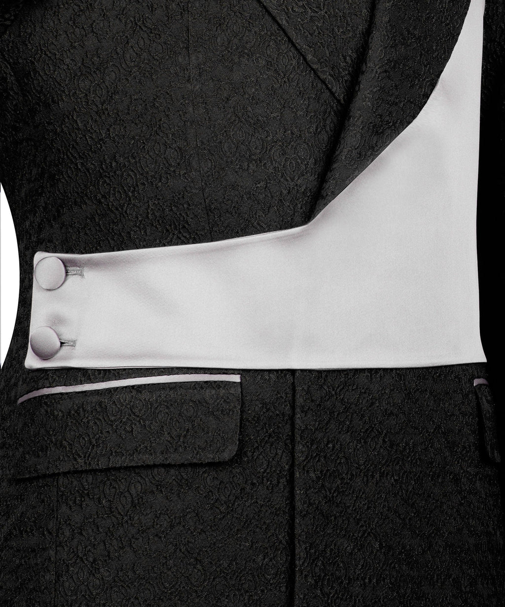 Close-up: light-gray satin vest panel with black buttons and tuxedo lapel