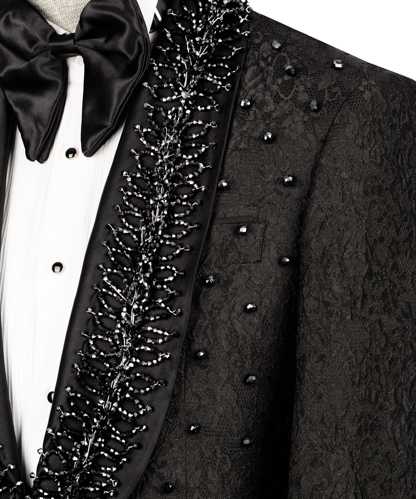 Close-up: black tuxedo lapel embroidery with bow tie and white shirt front
