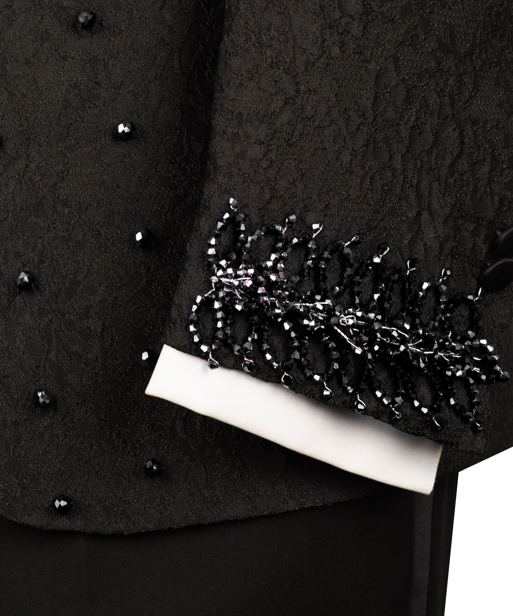 Black tuxedo sleeve cuff with sparkling embroidered trim detail