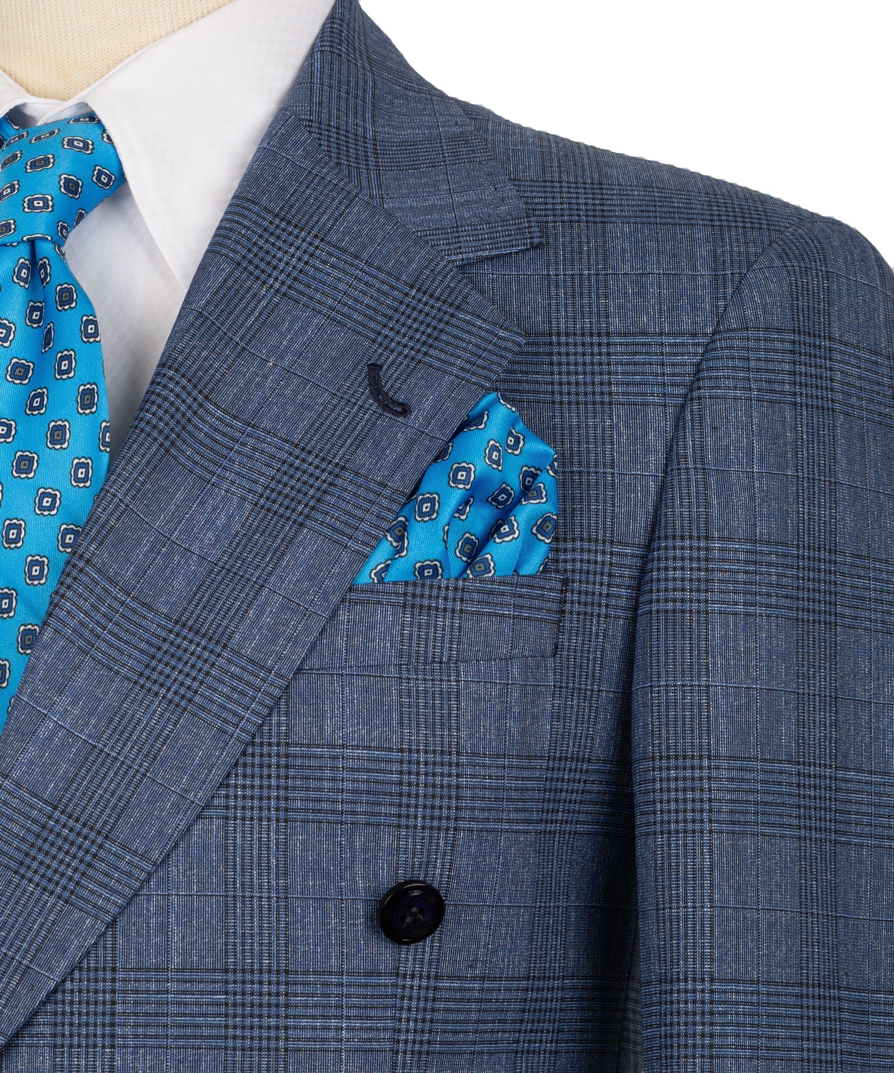 Blue plaid blazer close-up with blue patterned pocket square and notch lapel