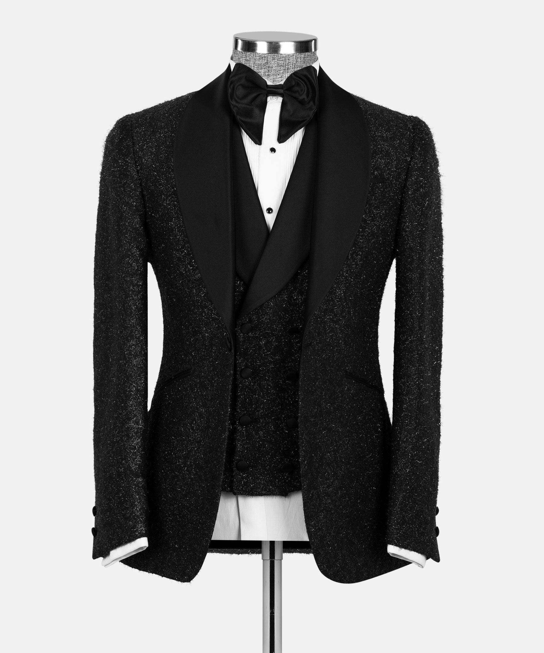 Black glitter tuxedo jacket with satin lapels and bow tie over white shirt