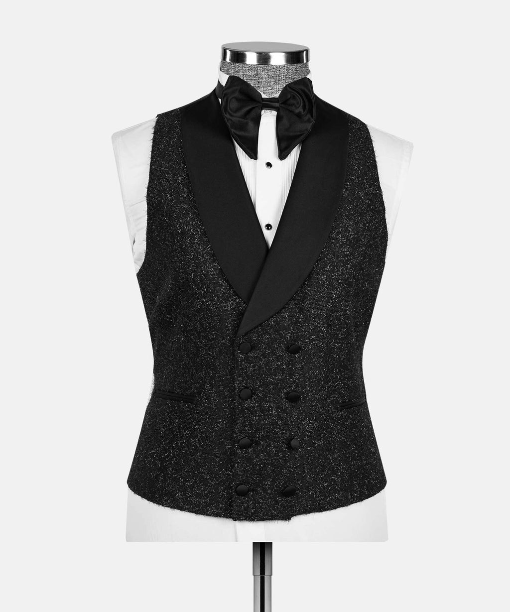 Black glitter tuxedo vest with satin lapels and bow tie over white shirt