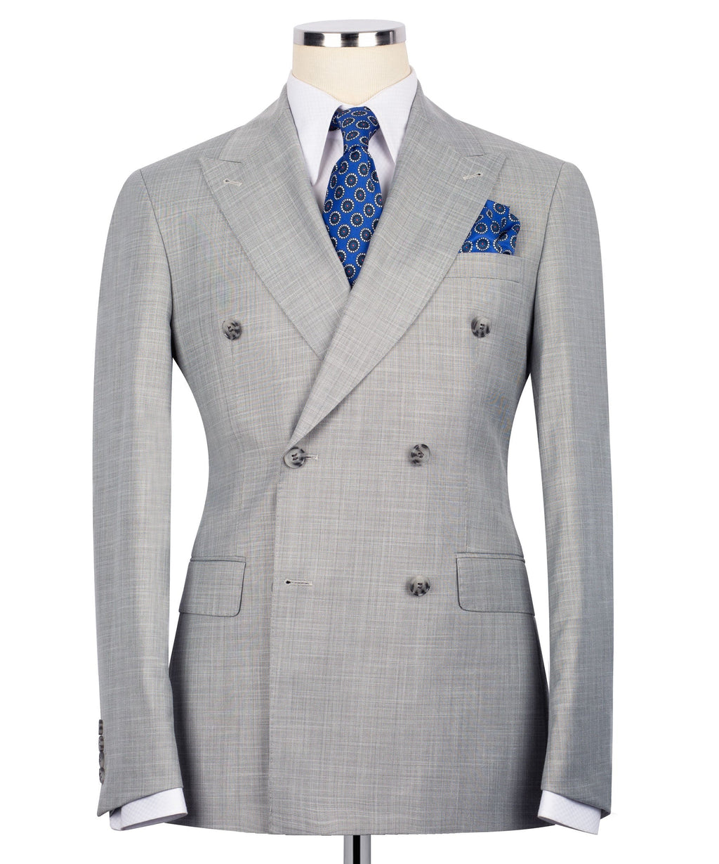 Gray double-breasted suit jacket with notch lapels, blue patterned tie, and pocket square