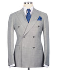 Gray double-breasted suit jacket with notch lapels, blue patterned tie, and pocket square