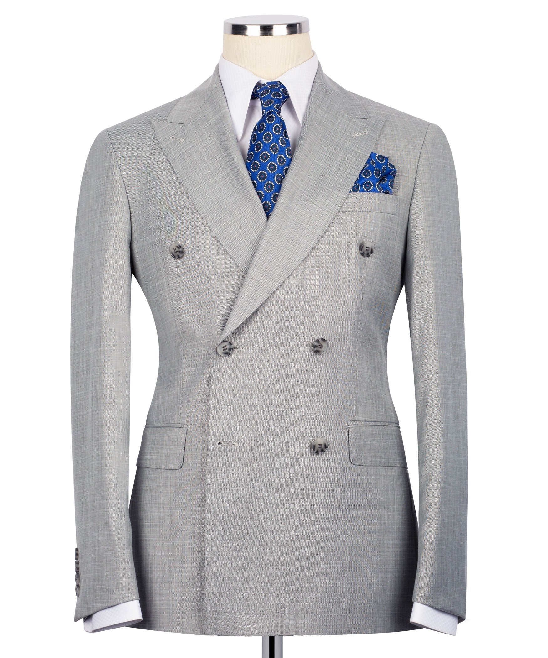 Gray double-breasted suit jacket with notch lapels, blue patterned tie, and pocket square