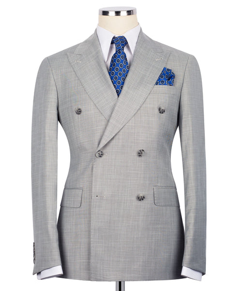 Gray double-breasted suit jacket with notch lapels, blue patterned tie, and pocket square