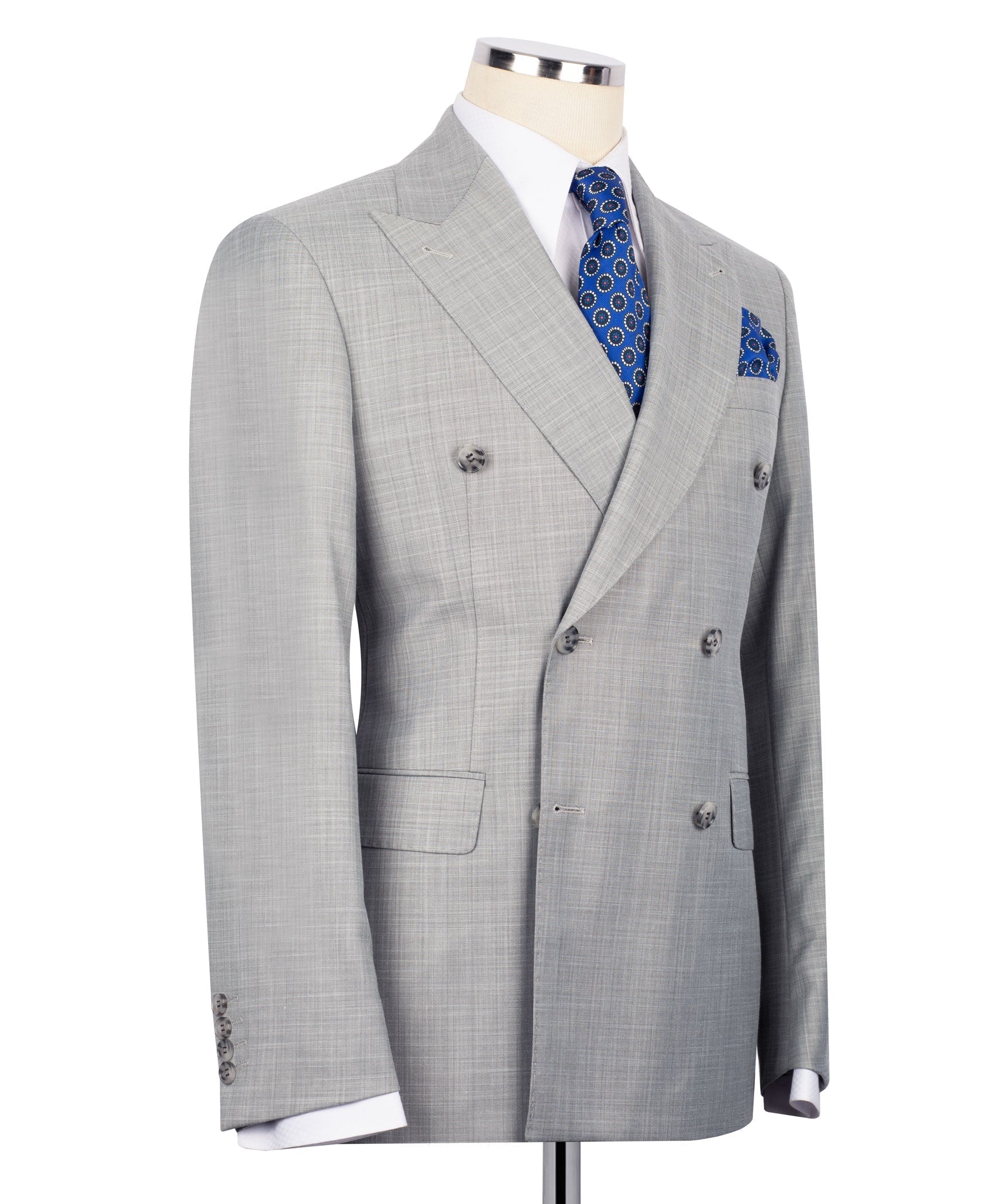 Gray double-breasted suit jacket side view, blue patterned tie and matching pocket square