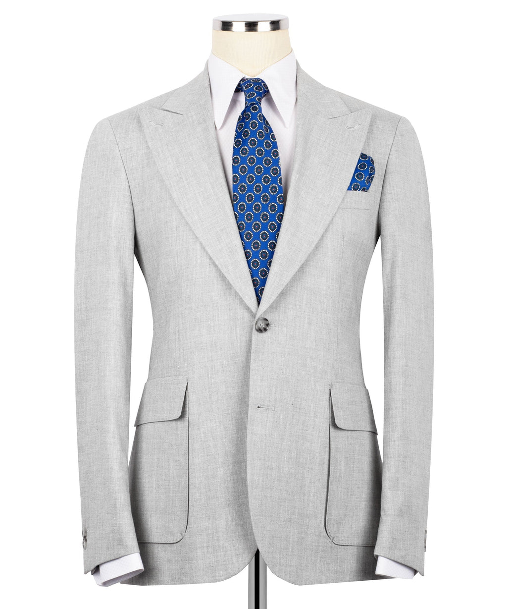 Light gray linen blazer with notch lapels, blue patterned tie, and matching pocket square