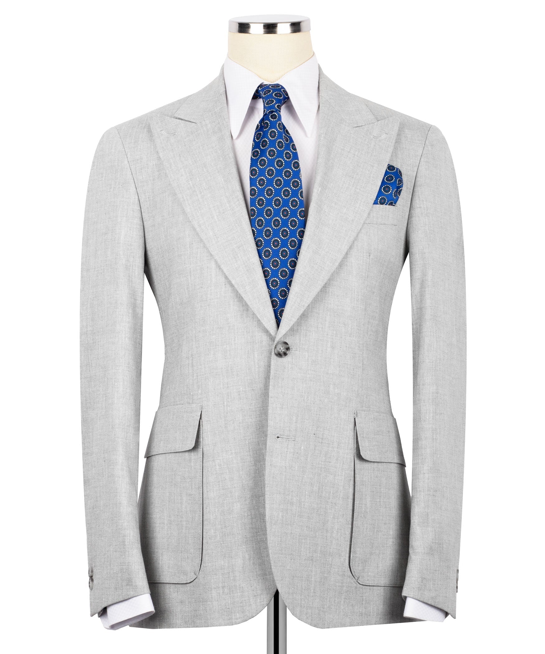 Light gray linen blazer with notch lapels, blue patterned tie, and matching pocket square