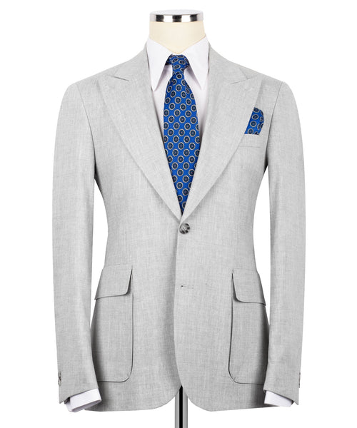 Light gray linen blazer with notch lapels, blue patterned tie, and matching pocket square