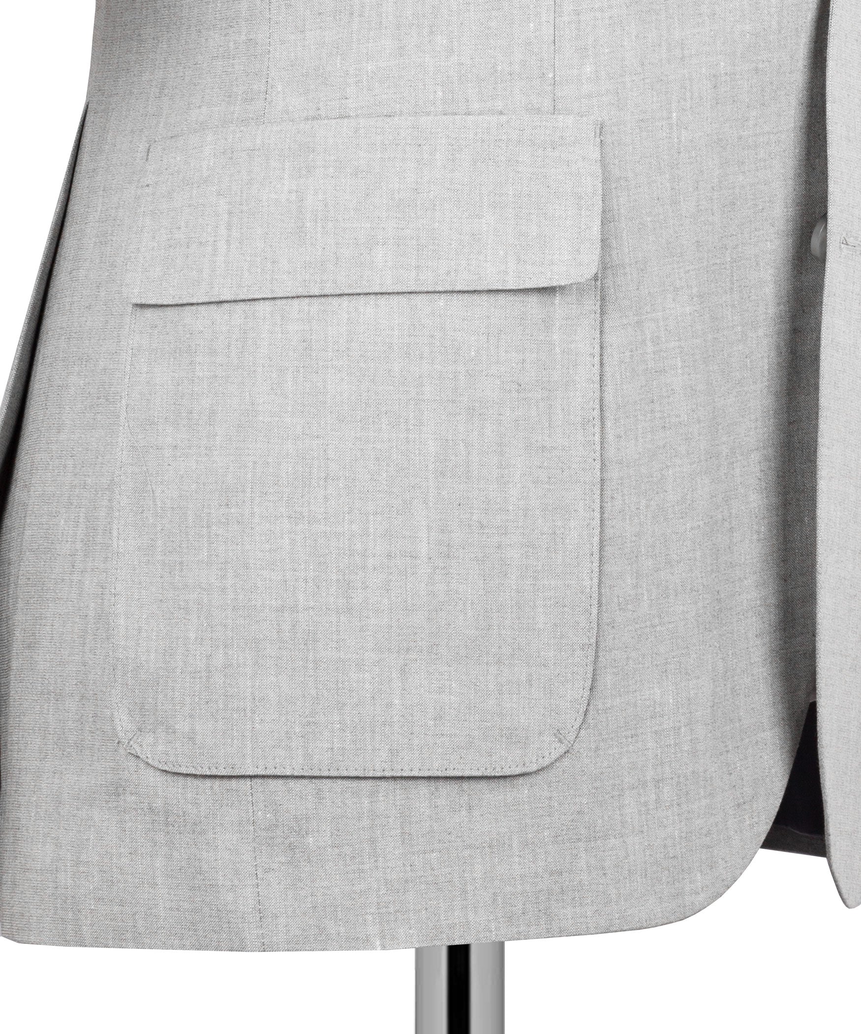 Light gray suit jacket close-up: welt pocket and smooth front panel