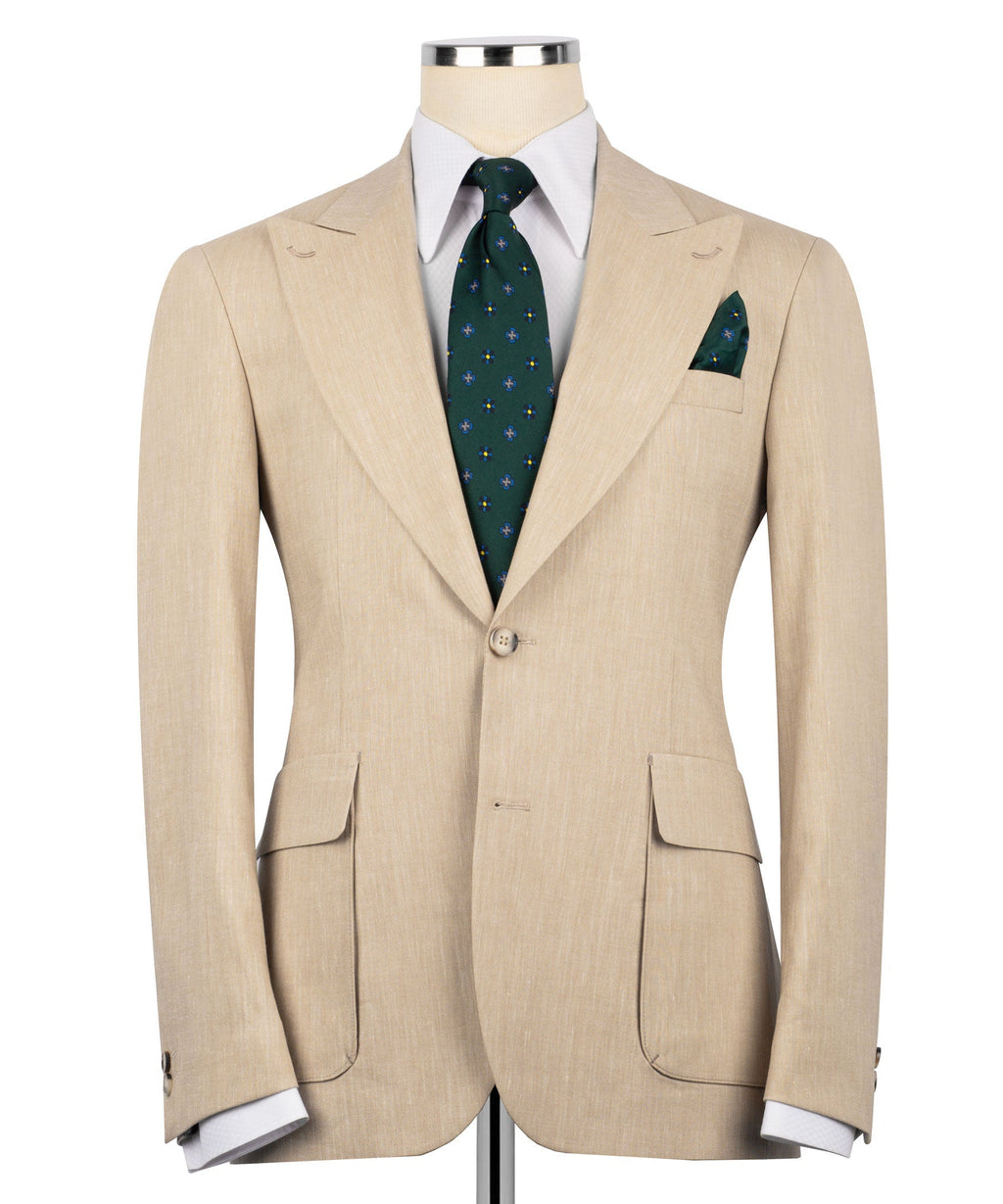 Beige linen suit jacket with flap pockets, plus green patterned tie and pocket square