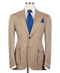 Tan linen blazer with notch lapels, two front pockets, blue patterned tie and pocket square