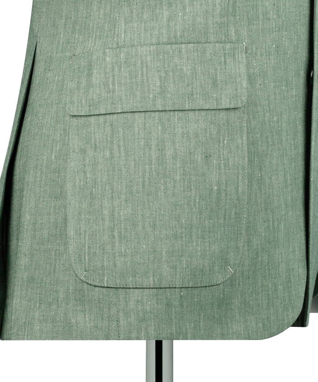 Close-up of green linen blazer front flap pocket and stitched seam detail