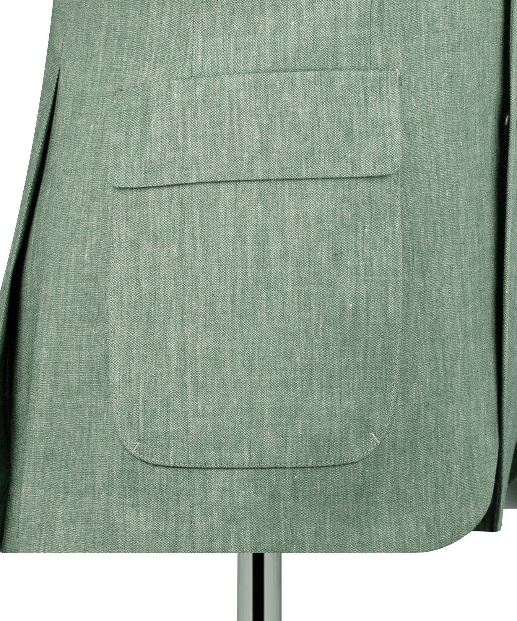 Close-up of green linen blazer front flap pocket and stitched seam detail