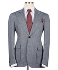 Grey linen suit jacket with notch lapel, front flap pockets, tie and pocket square