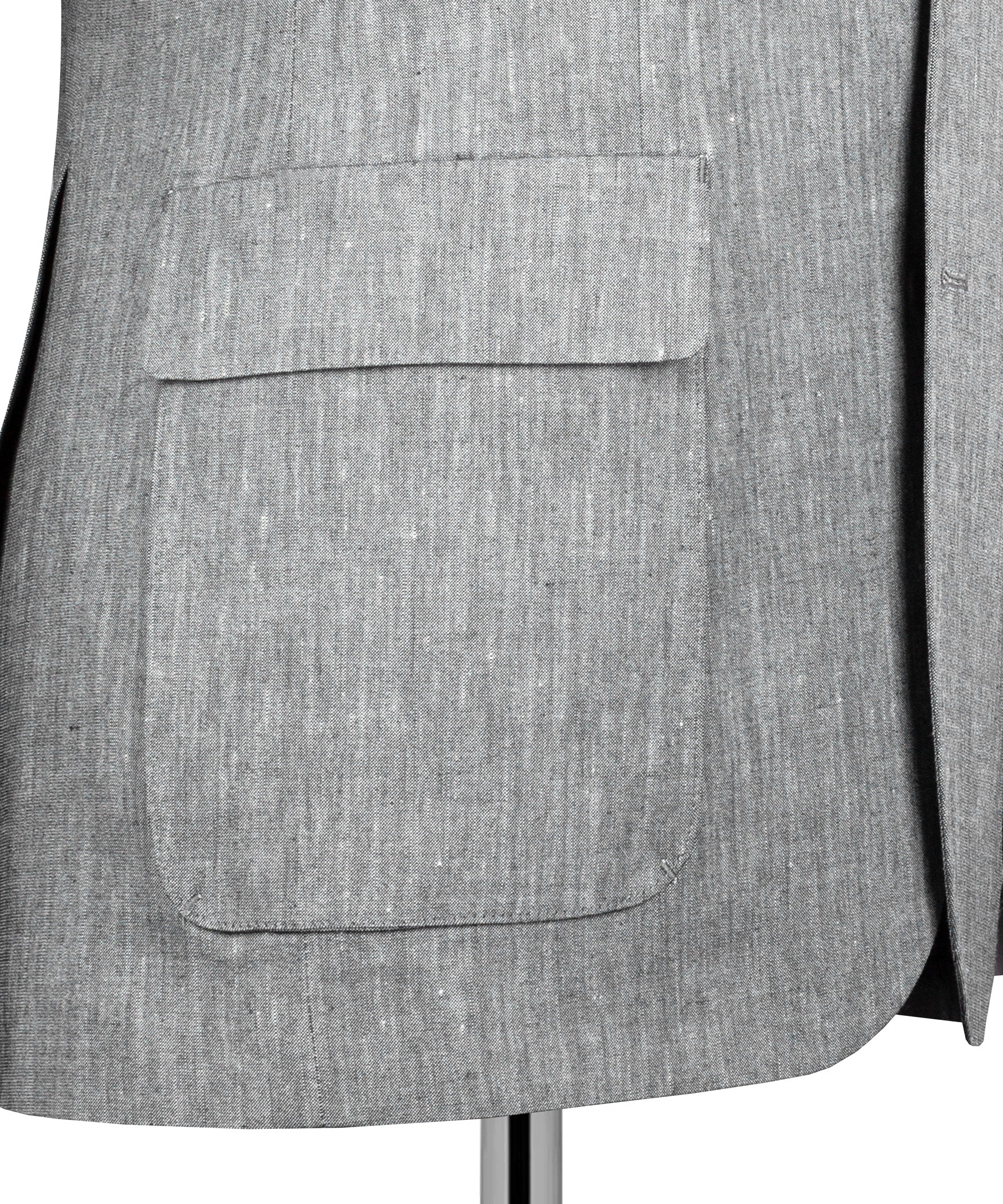 Gray suit jacket front pocket detail with flap and single button