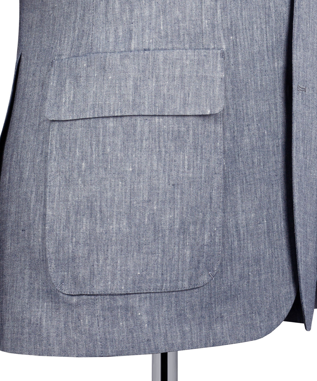 Grey linen suit jacket lower front with flap pocket detail and clean hem