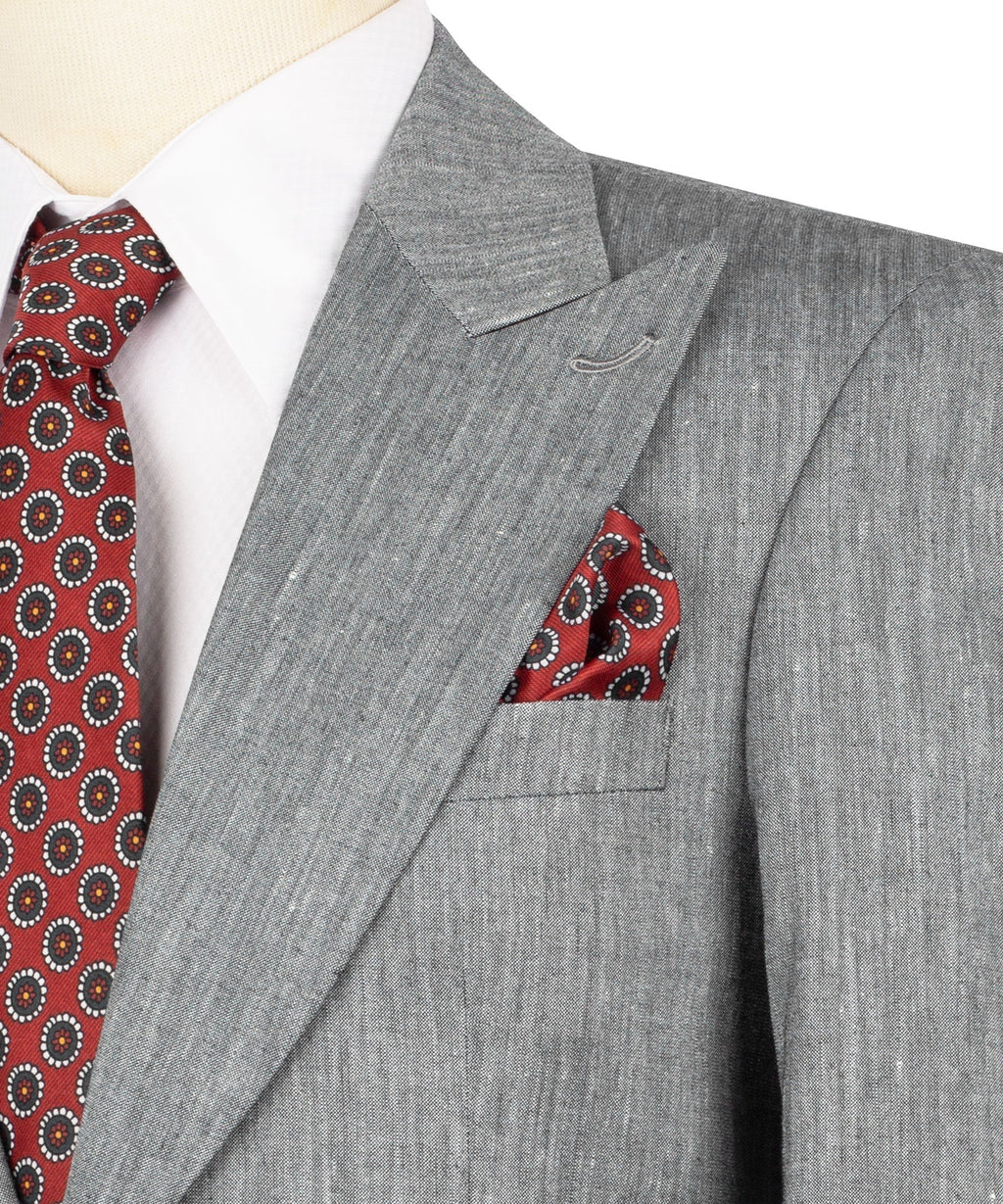 Close-up: gray suit jacket lapel with red patterned tie and red pocket square