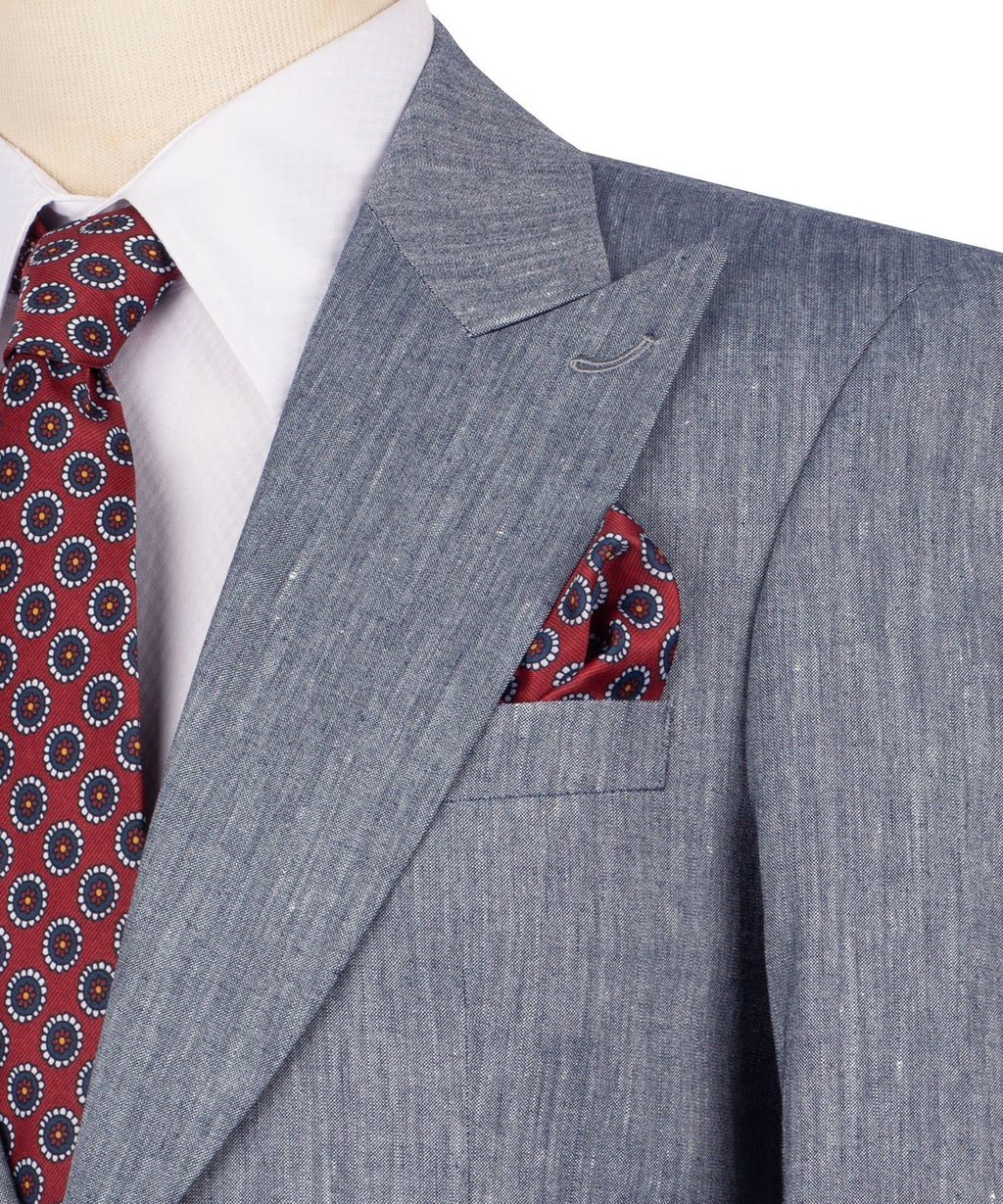 Grey linen suit jacket close-up with maroon patterned pocket square and lapel