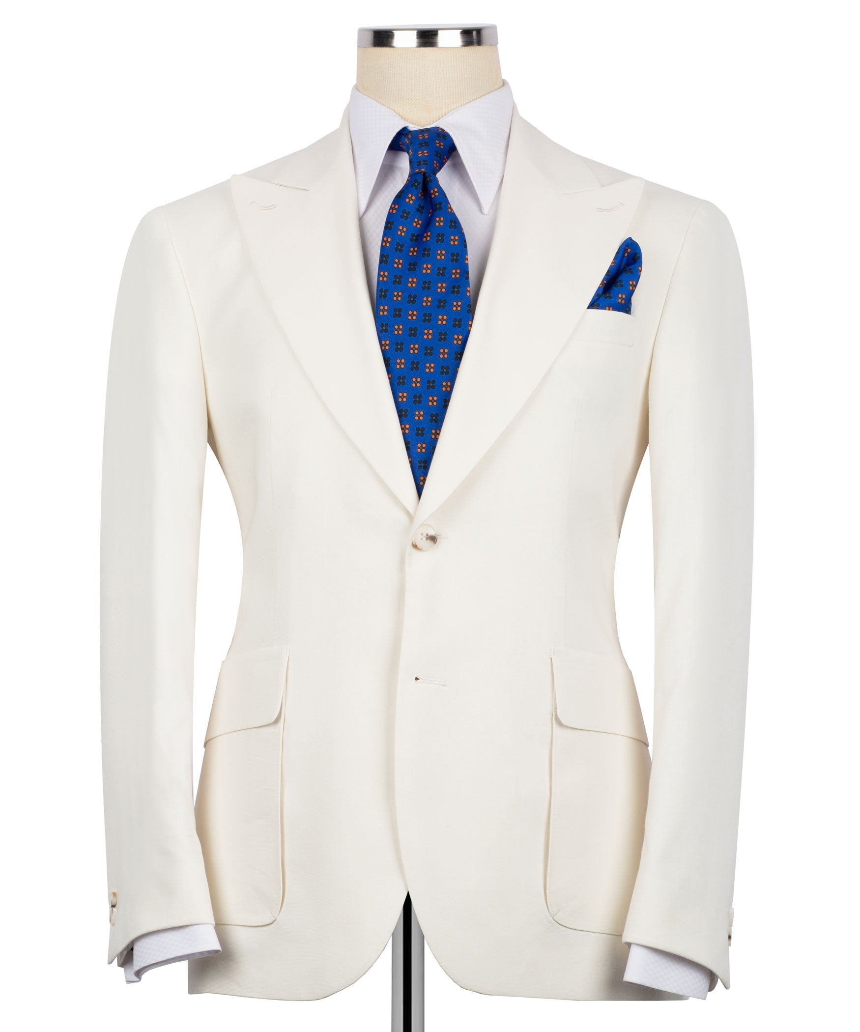 Cream linen blazer with notch lapels, flap pockets, and blue tie + pocket square