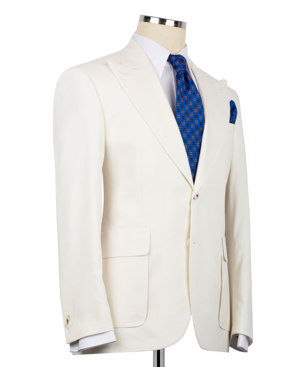 Cream linen blazer side view with single-breasted front and flap pockets