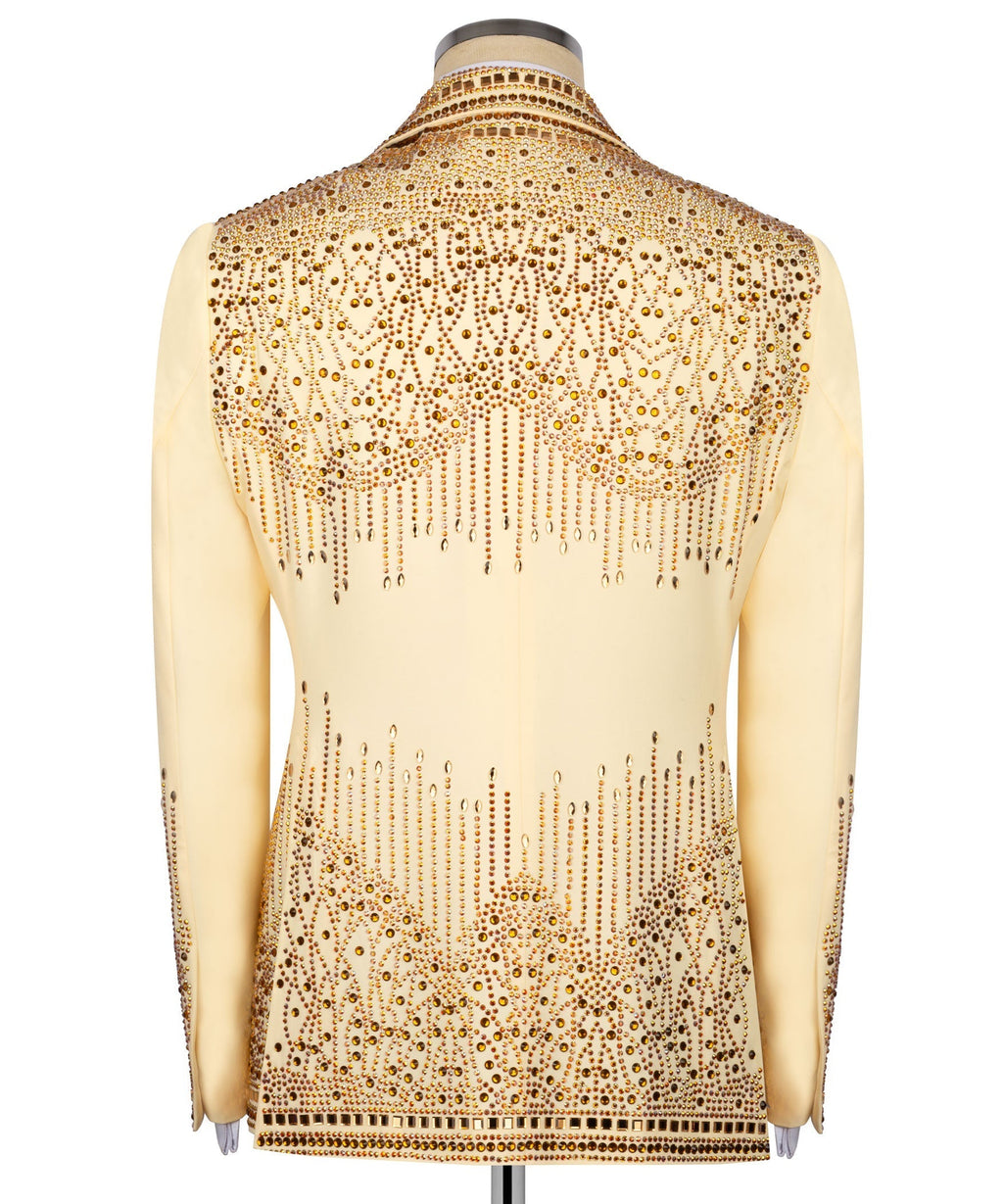 Back view of yellow tuxedo jacket with dense gold stone embroidery and button details