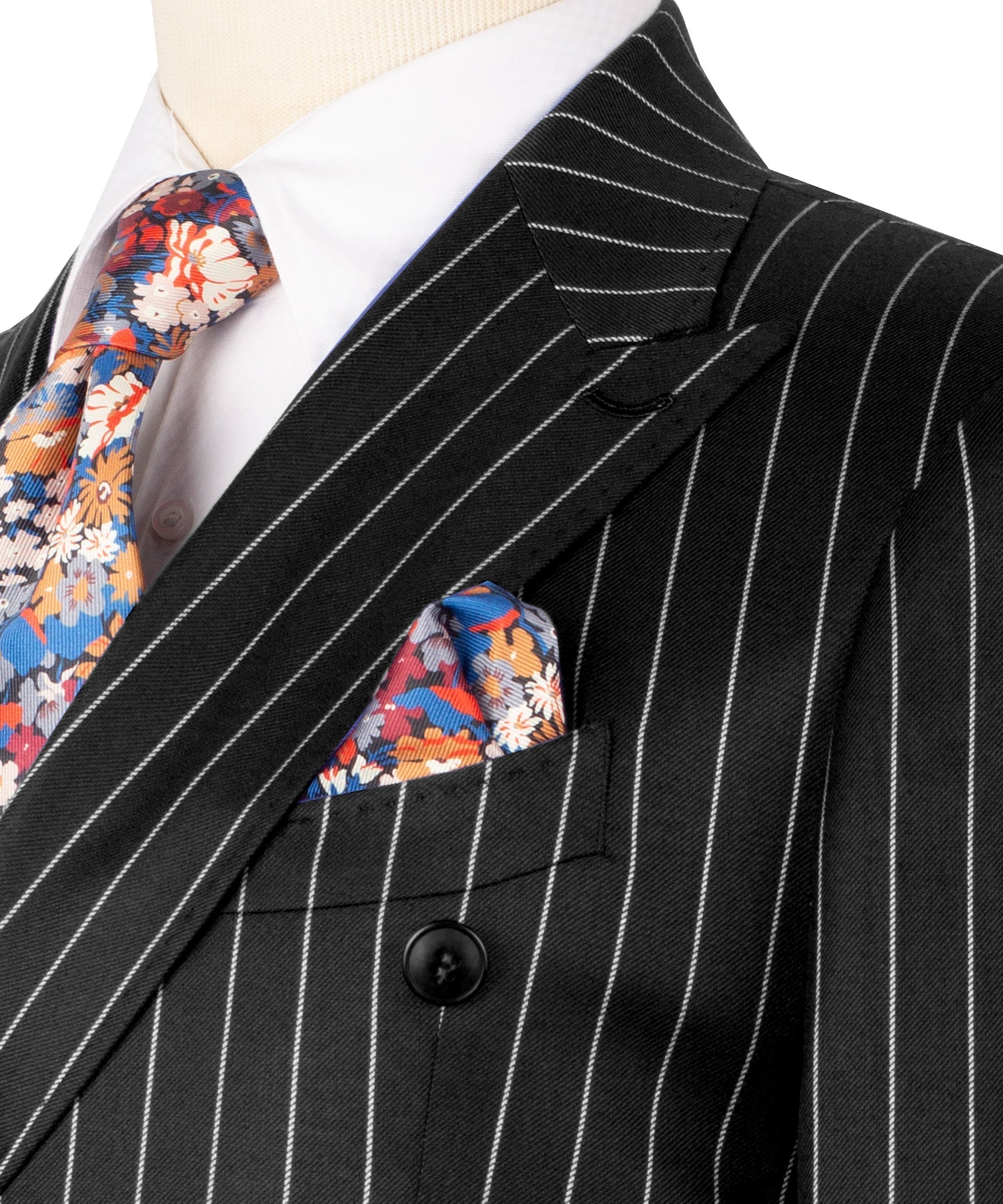 Black pinstripe suit jacket lapel with colorful floral pocket square and tie