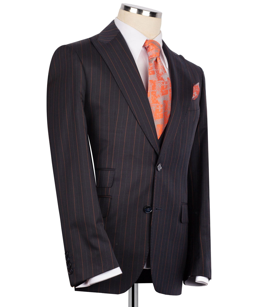 Dark pinstripe suit blazer with peak lapel, orange patterned tie, and chest pocket