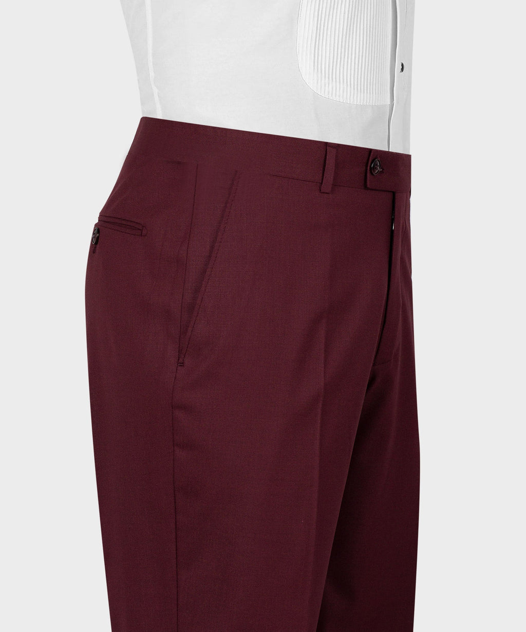 Burgundy tailored trousers with belt loops, pleats, and button closure