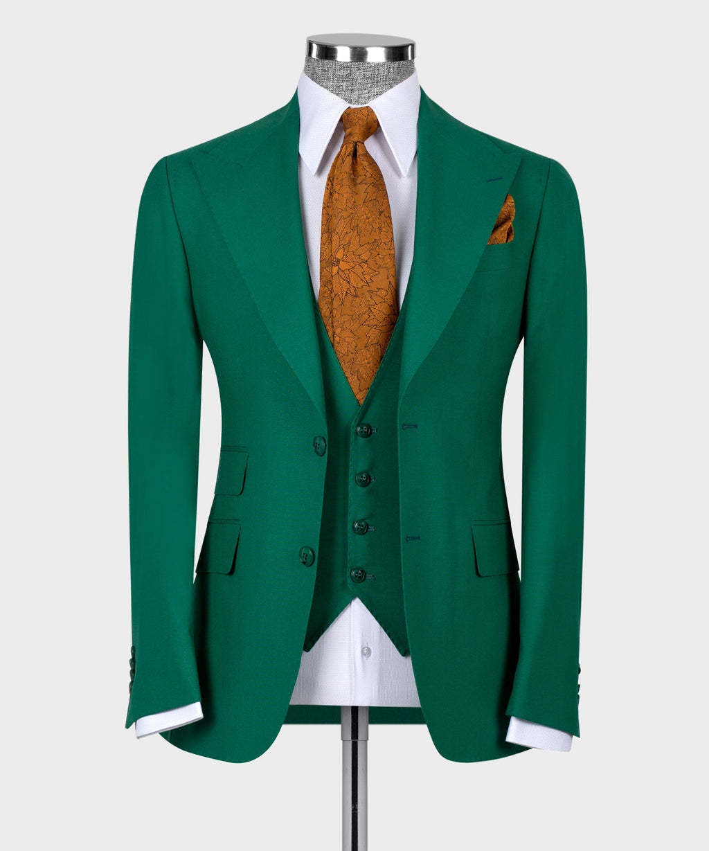 Green tailored suit jacket and waistcoat with white shirt, orange patterned tie