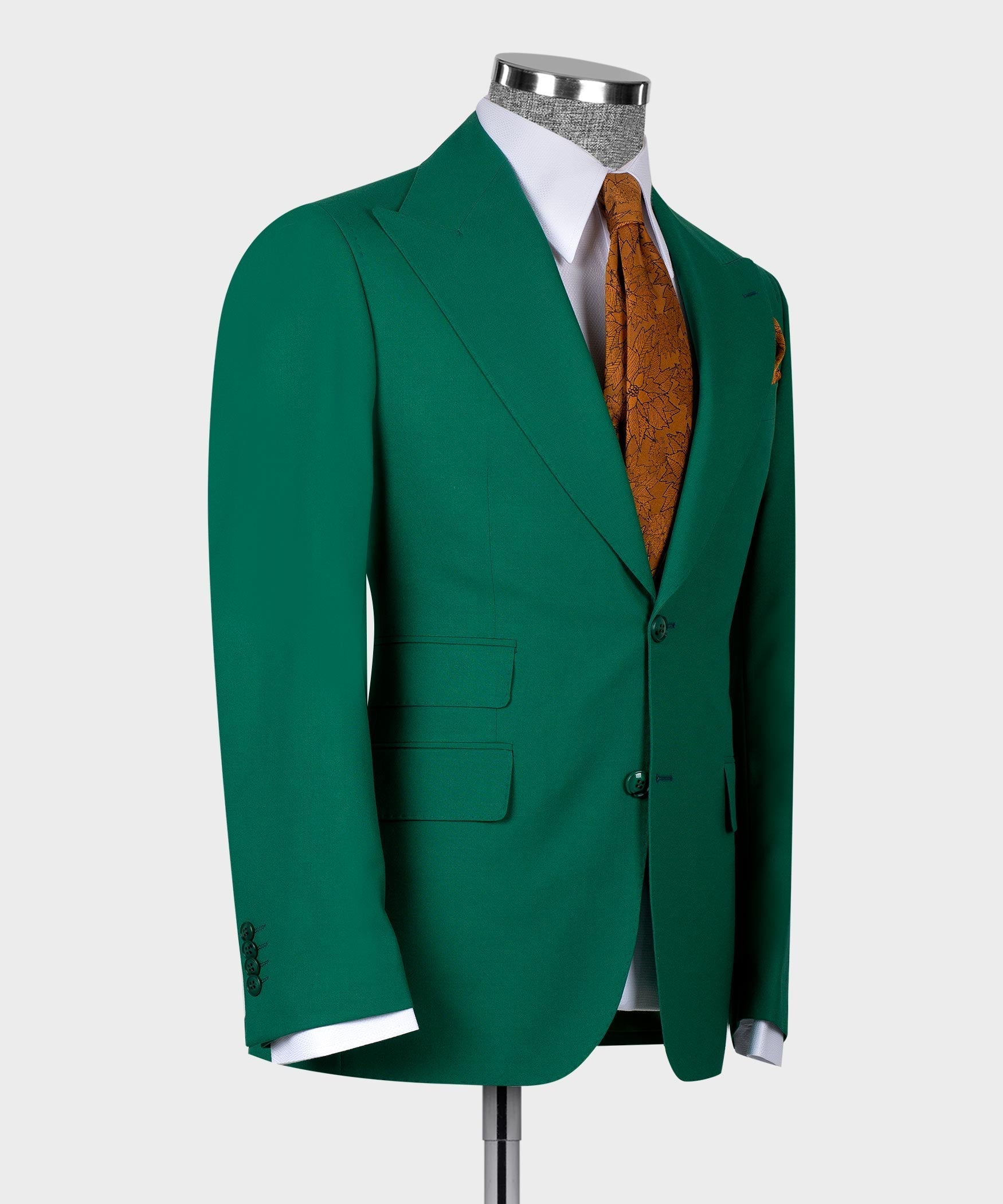 Green suit jacket on mannequin, showing single-breasted waistcoat and orange tie
