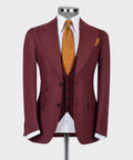 Burgundy tailored suit jacket with white shirt, mustard patterned tie, dark vest
