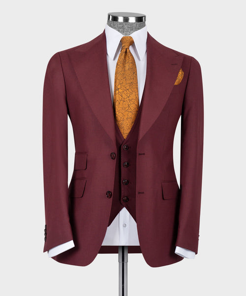Burgundy tailored suit jacket with white shirt, mustard patterned tie, dark vest